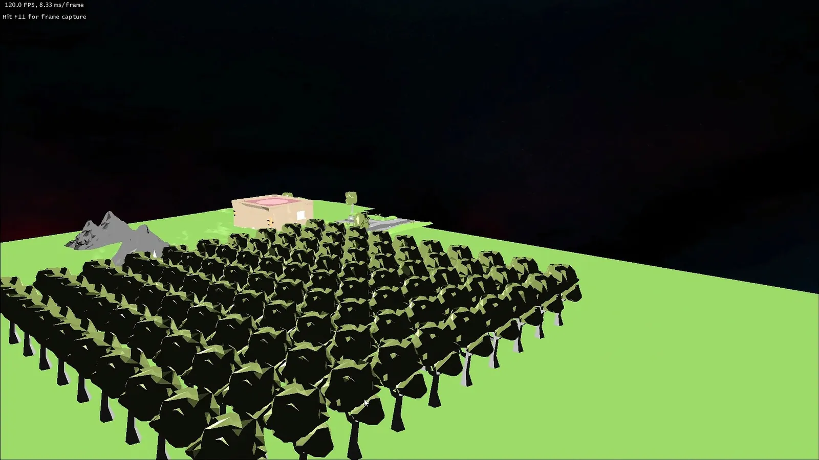 A low-poly forest of dark green trees on bright grass with grey mountains and a building under a night sky